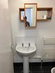 a person taking a picture of a sink in a bathroom at 36 Park Road Lenton in Nottingham