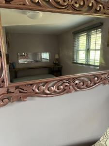 a large mirror on a wall in a room at Close to Nature Hedgehogs Lodge in South Molton