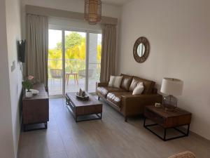 a living room with a couch and a table at Hard Rock at Cana Pearl 1 by Unwind Properties in Punta Cana
