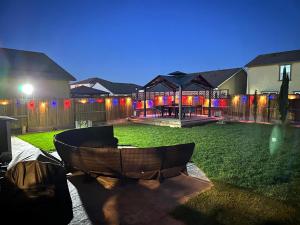 a backyard at night with a patio and a lawn at #stayRioVista Farmhouse near river- Entire House with RV parking in Rio Vista