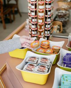 a person is reaching into a container of food at EGG HOTEL - HOTEL LES GENS DE MER Dieppe in Dieppe