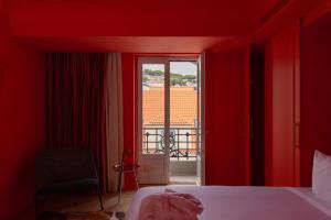Postel nebo postele na pokoji v ubytování Art Legacy Hotel Baixa-Chiado