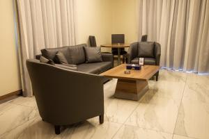 a living room with two couches and a coffee table at Ibiza Hotel in Jounieh