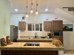 A kitchen or kitchenette at Chicxulub Puerto Beach Penthouse