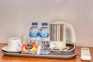 a tray with bottles of water and a blender at Ananta Bungalow in Nusa Penida