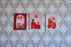 three illustrations of buildings on a patterned wallpaper at Apartment Sea View B4 - Mosquée Hassan II - By THECASAEDITION in Casablanca