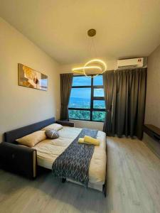 a bedroom with a bed and a large window at CC Suites Jesselton Quay - Seaview - 2Bedroom in Kota Kinabalu