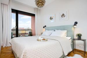 a bedroom with a large bed with a white bedspread at Old Town Fabulous view apartment in Tallinn