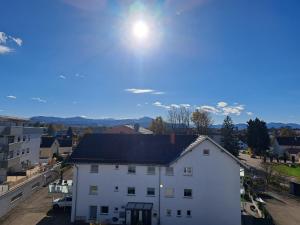 a white building with the sun in the sky at Ferienwohnung im Allgäu in Durach