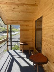 a wooden cabin with a bench and a window at Guesthouse Shete 