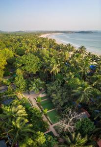 an aerial view of a resort with a beach and palm trees at Oxygen Palolem in Palolem