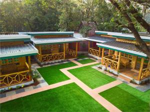 an overhead view of a building with green grass at Oxygen Palolem in Palolem