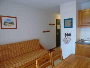 a living room with a couch and a table at Appartement Valfréjus, 2 pièces, 4 personnes - FR-1-561-32 in Valfréjus