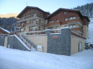 a large building with snow in front of it at Appartement Valfréjus, 2 pièces, 4 personnes - FR-1-561-32 in Valfréjus