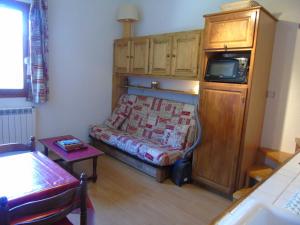 a small living room with a bed and a tv at Appartement Valfréjus, 2 pièces, 4 personnes - FR-1-561-50 in Valfréjus