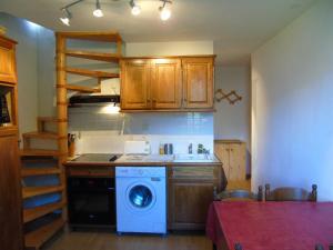 a kitchen with a stove and a washing machine at Appartement Valfréjus, 2 pièces, 4 personnes - FR-1-561-50 in Valfréjus