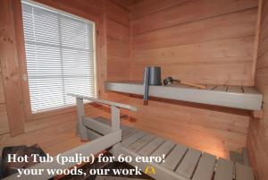 a room with a wooden wall with a bench and a window at SResort Saunas - hot tub, palju in Imatra