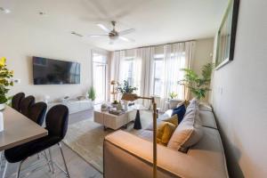 a living room with a couch and a tv at Spacious Luxury Apartment in Galleria HTX in Houston