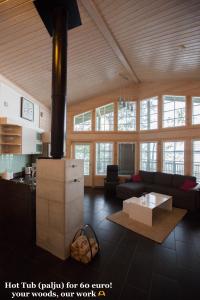 a living room with a couch and a table at SResort Saunas - hot tub, palju in Imatra