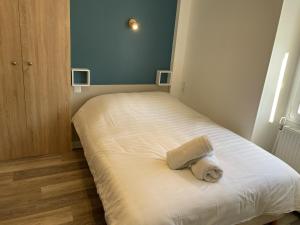 a small bedroom with a bed with a towel on it at Studio Aix-les-Bains, 1 pièce, 2 personnes - FR-1-617-23 in Aix-les-Bains