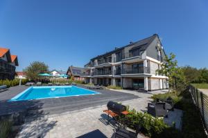 an image of a house with a swimming pool at Inny Klimat in Rowy