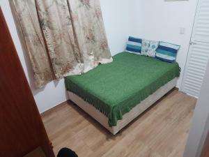 een klein bed in een kamer met een raam bij Hostel Sancris in São José dos Campos