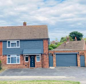 a large brick house with a garage at Gatwick Studio in Horley