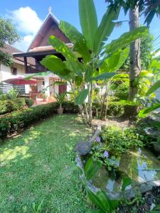 a garden in front of a house at Luang Prabang Residence & Travel in Luang Prabang