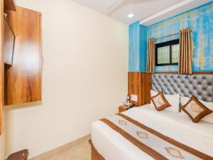 Postel nebo postele na pokoji v ubytování Hotel BKC Fortune