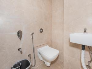 a bathroom with a toilet and a sink at Hotel BKC Fortune in Mumbai