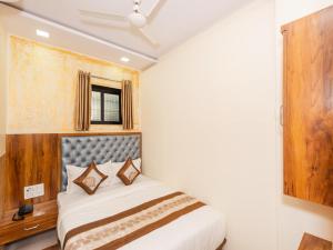 Postel nebo postele na pokoji v ubytování Hotel BKC Fortune