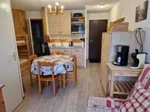 a small kitchen with a table and chairs in a room at Appartement La Plagne Montalbert , 2 pièces, 4 personnes - FR-1-755-4 in Aime-La Plagne