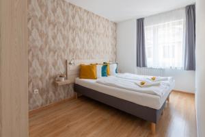 Postel nebo postele na pokoji v ubytování Prince Apartments