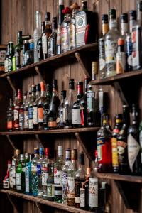 a shelf filled with lots of different types of alcohol at Boutique Hotel Anna by EJ Hotels in Holt