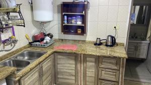 a kitchen with a sink and a counter top at Jerash sky1 in Jerash
