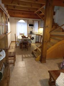 a kitchen and living room with a staircase in a house at Complejo Paimun in San Martín de los Andes