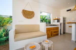 a living room with a couch and a kitchen at Villa Zahka - 1BR Private Luxury Hideaway near Seseh Beach in Canggu