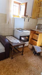 a kitchen with a stove and a table in it at سراييفو Sarajevo apartment in Sarajevo