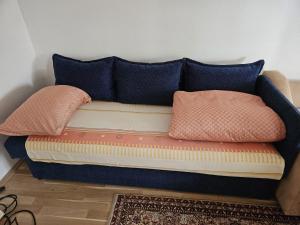a couch with pillows on it in a room at سراييفو Sarajevo apartment in Sarajevo