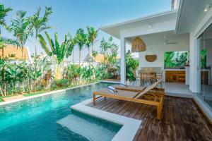 a villa with a swimming pool and a dining area at Villa Zahka - 1BR Private Luxury Hideaway near Seseh Beach in Canggu +19 photos