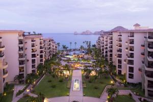 an aerial view of buildings and the ocean at dusk at Villa la Estancia Beach Resort & Spa in Cabo San Lucas