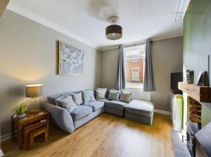 a living room with a couch and a table at The Terrace Hoole, cosy modern 2 bedroom house in Chester