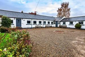 a large white building with a lot of windows at Finest Retreats - Woodstock Lodge in Bishop Middleham