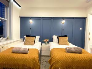 dos camas sentadas una al lado de la otra en una habitación en Central penthouse by HNFC Stays en Newcastle