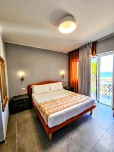 a bedroom with a large bed and a balcony at A Casa di Alessandra - Rooms in Castellabate