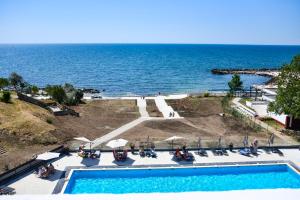 a swimming pool with the ocean in the background at HOTEL TOPAZ 4* CAP AURORA in Cap Aurora