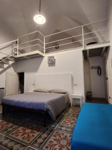 a bedroom with a large bed and a loft at Malvasia room and apartment in Brindisi