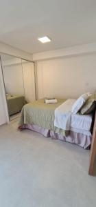 una camera da letto con un letto grande in una stanza di Studio no centro com piscina a Juiz de Fora