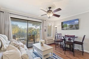 uma sala de estar com um sofá e uma ventoinha de tecto em Seaside Villa 251 em Hilton Head Island