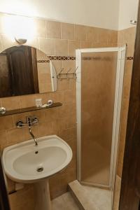 a bathroom with a sink and a shower at Penzión Kúria in Dolný Kubín